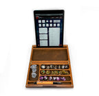 Wooden dice tray with dice and a tablet displaying a game interface on a white background