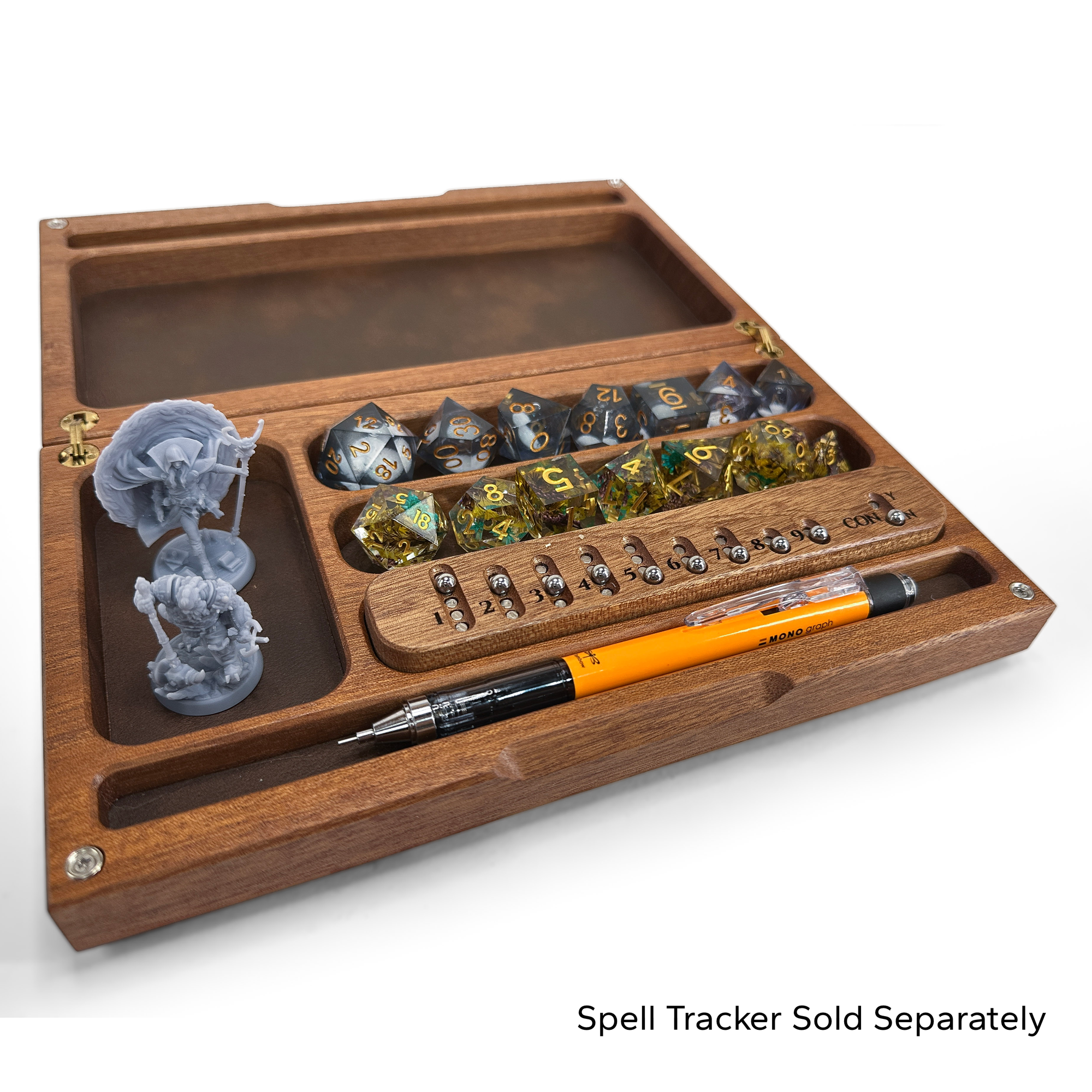 Wooden dice box with dice, miniatures, and a pen on a white background